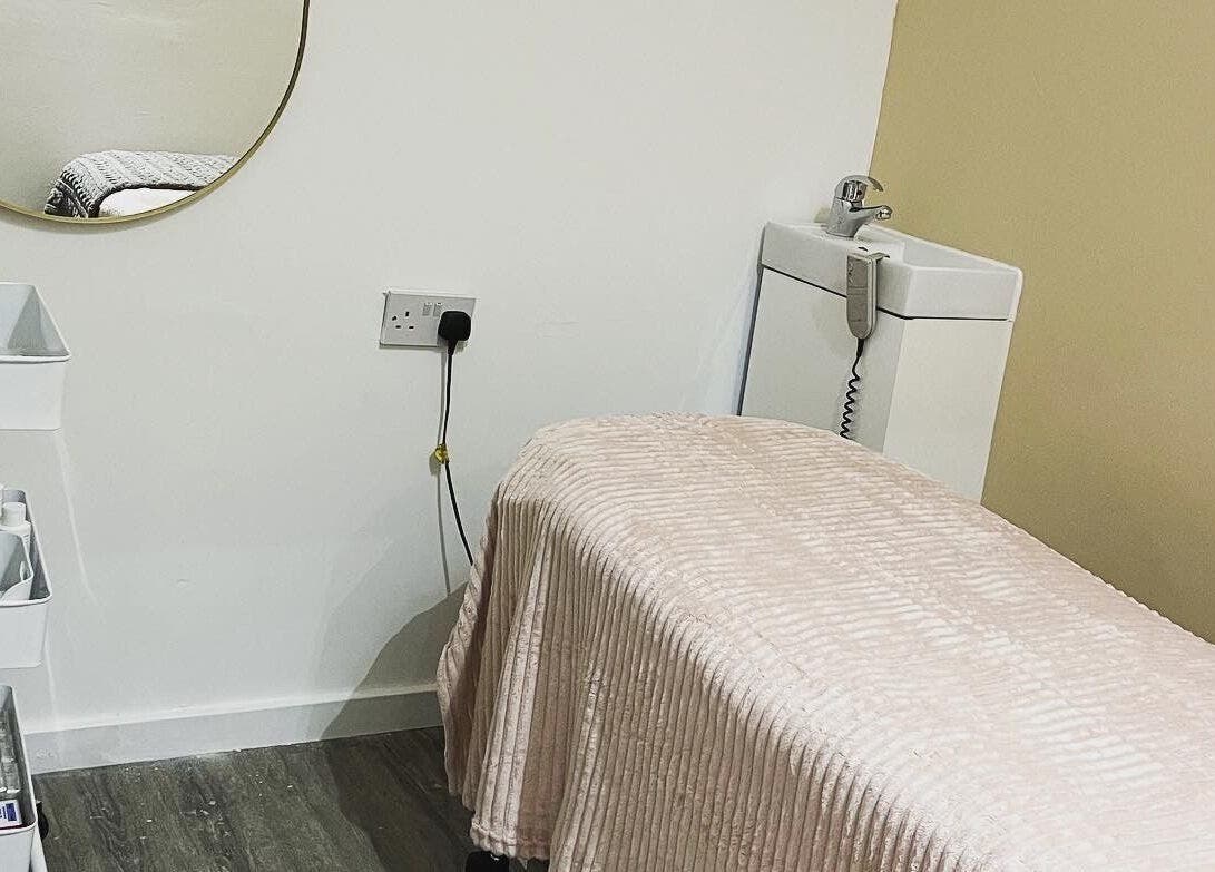 Cozy treatment room at Faith. Hair and Beauty, Chislehurst, England, GB, featuring a plush bed and serene ambiance.