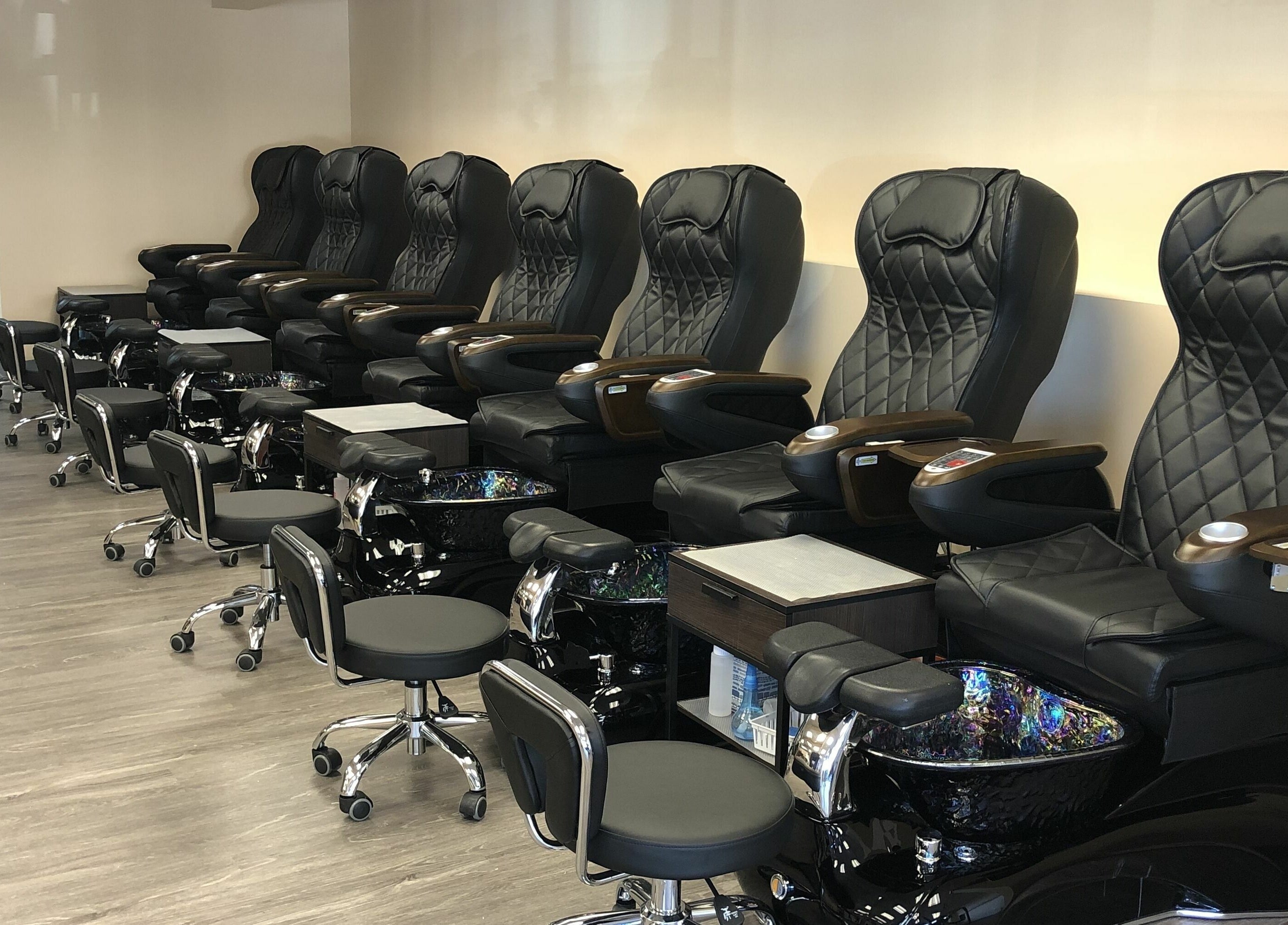 Luxurious pedicure chairs lined up at Orange Nail Studio in Beverly, Massachusetts, US.