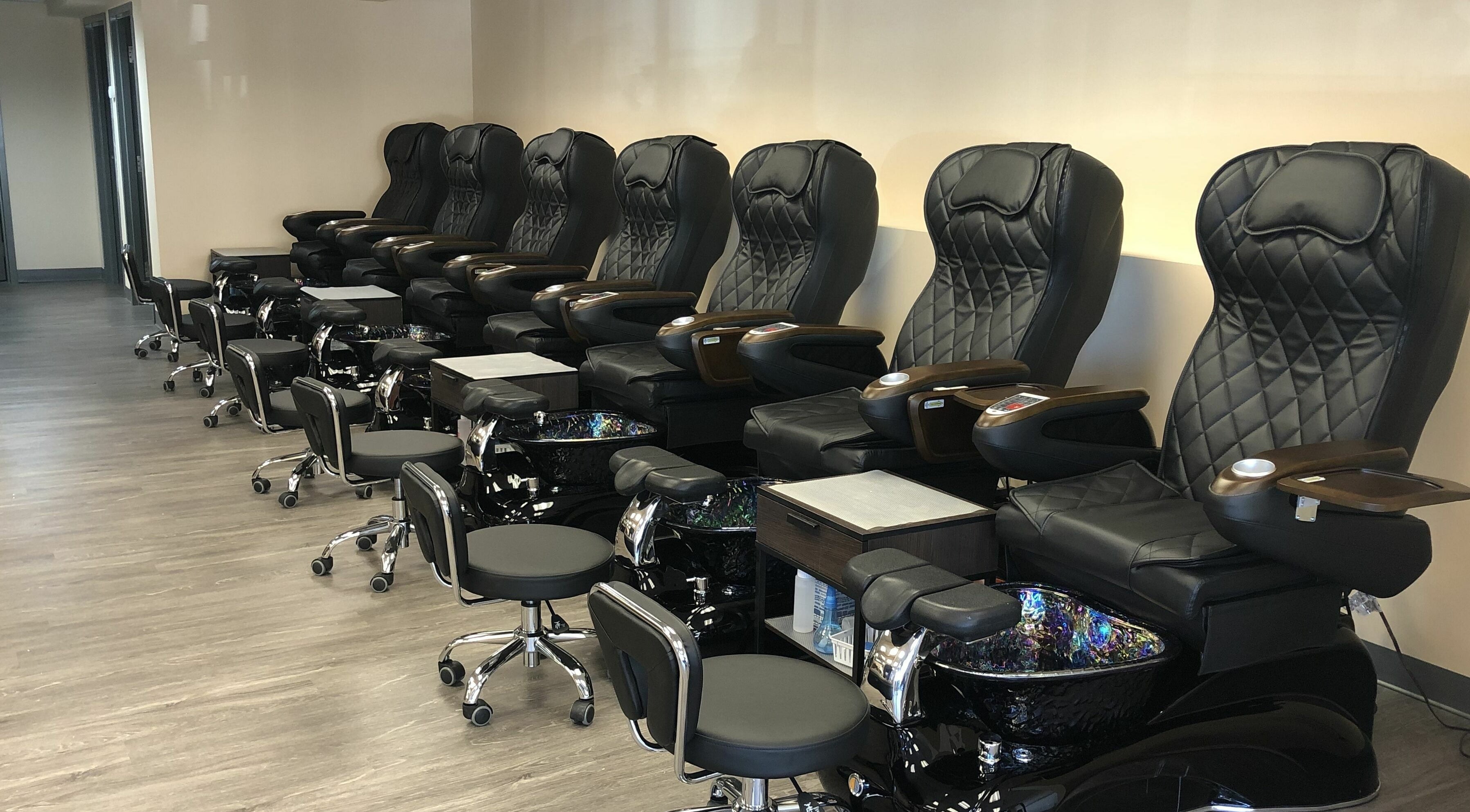 Luxurious pedicure chairs lined up at Orange Nail Studio in Beverly, Massachusetts, US.