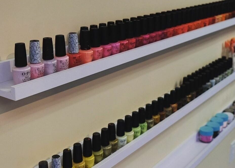 Colorful nail polish display at Orange Nail Studio, Beverly, Massachusetts, US showcases variety and style.