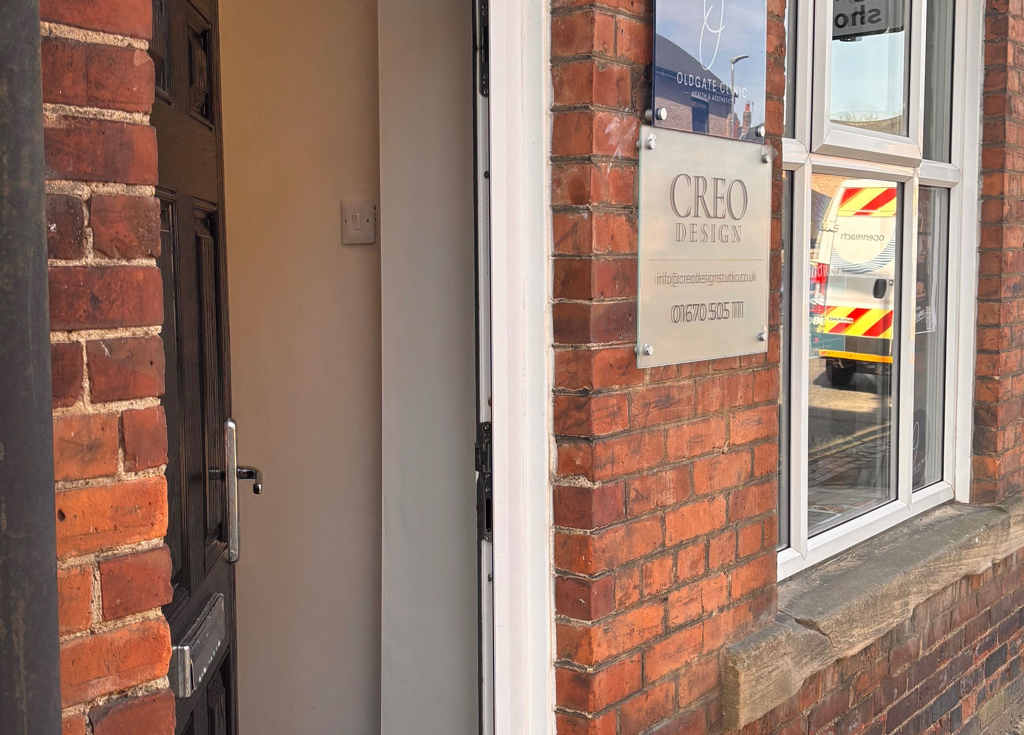 Entrance of Urban Spa, Morpeth, England, GB with brick facade and window signage.