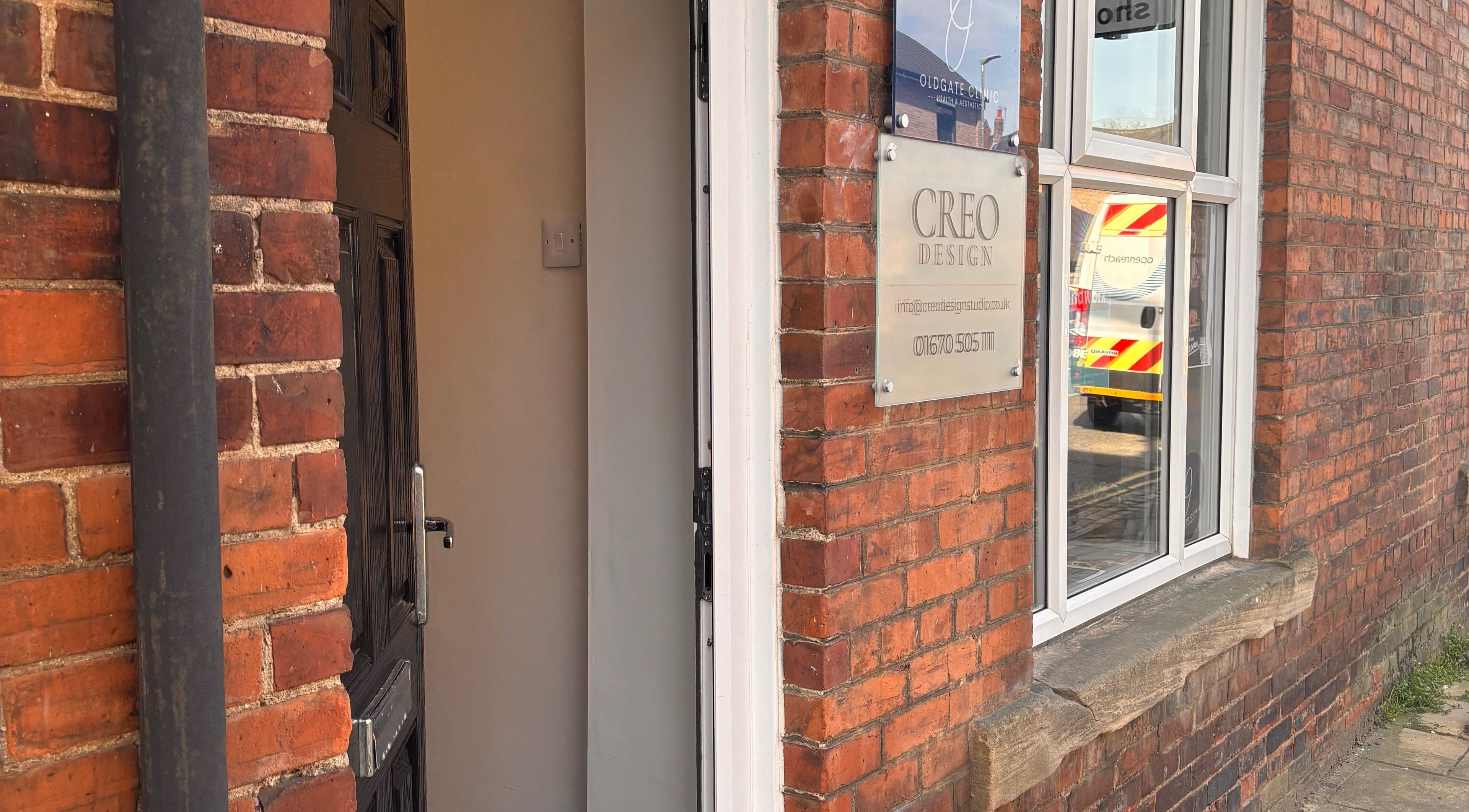 Entrance of Urban Spa, Morpeth, England, GB with brick facade and window signage.