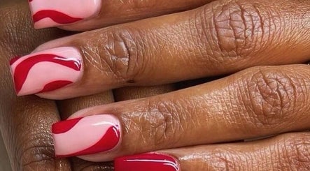 Elegant red swirl nail art at Beauticave in Krugersdorp, Gauteng, ZA. Perfect for stylish manicures.
