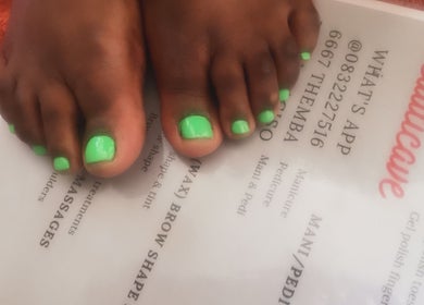 Neon green pedicure at Beauticave in Krugersdorp, Gauteng, ZA. A vibrant nail treatment against salon menu.