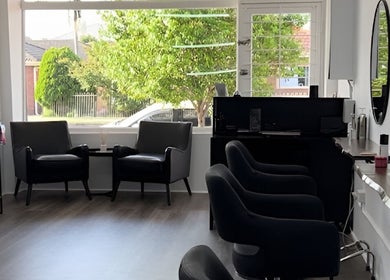 Inviting interior of BW Hair in East Corrimal, New South Wales, AU, featuring stylish chairs and large windows.