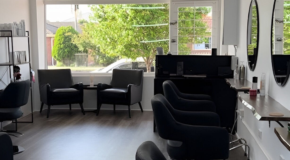 Inviting interior of BW Hair in East Corrimal, New South Wales, AU, featuring stylish chairs and large windows.