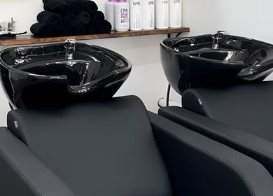 Modern shampoo wash stations at BW Hair, East Corrimal, New South Wales, AU showcasing sleek black design.