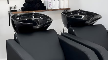 Modern shampoo wash stations at BW Hair, East Corrimal, New South Wales, AU showcasing sleek black design.