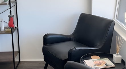 Relax in style at BW Hair, East Corrimal, with our sleek black armchair in a serene setting.