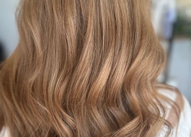 Smooth, glossy hair at BW Hair, East Corrimal, New South Wales, AU, showcasing vibrant brown color and soft waves.