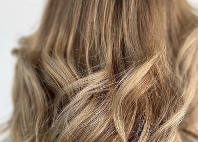 Blonde wavy hairstyle at BW Hair in East Corrimal, New South Wales, AU, showcasing vibrant color and texture.