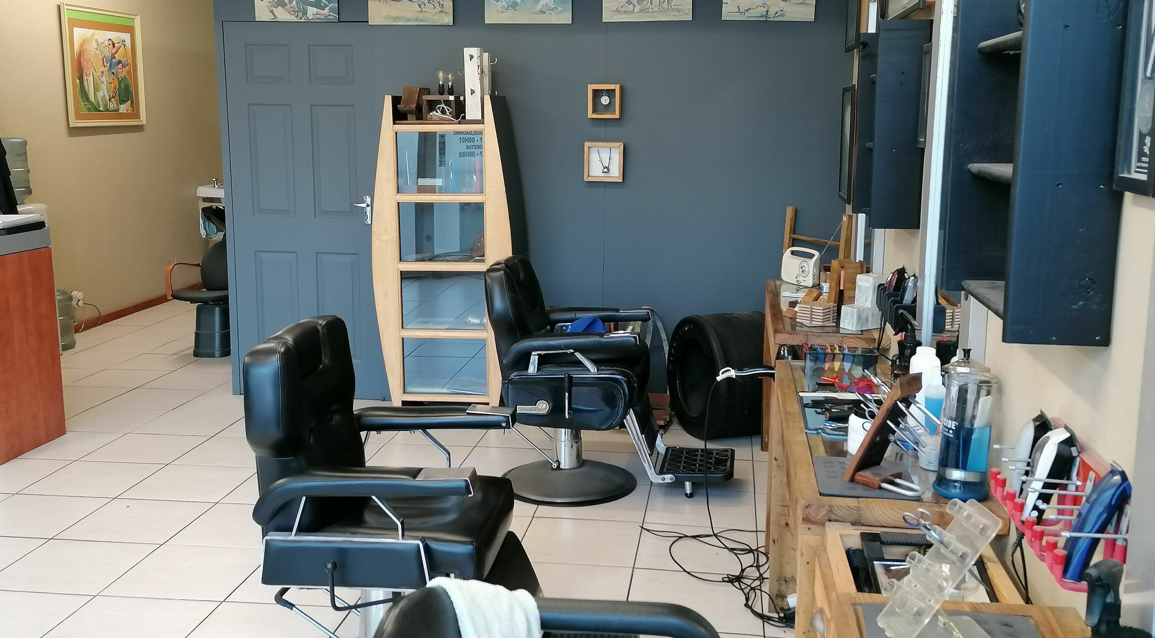 Inside Sport Top Mens Hairsalon, Cape Town, Western Cape, ZA featuring modern barber chairs and styling tools.