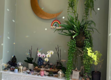 Decorative nook at Alchemy Lab, Dublin, Dublin, IE with plants, crescent moon, and rainbow art.