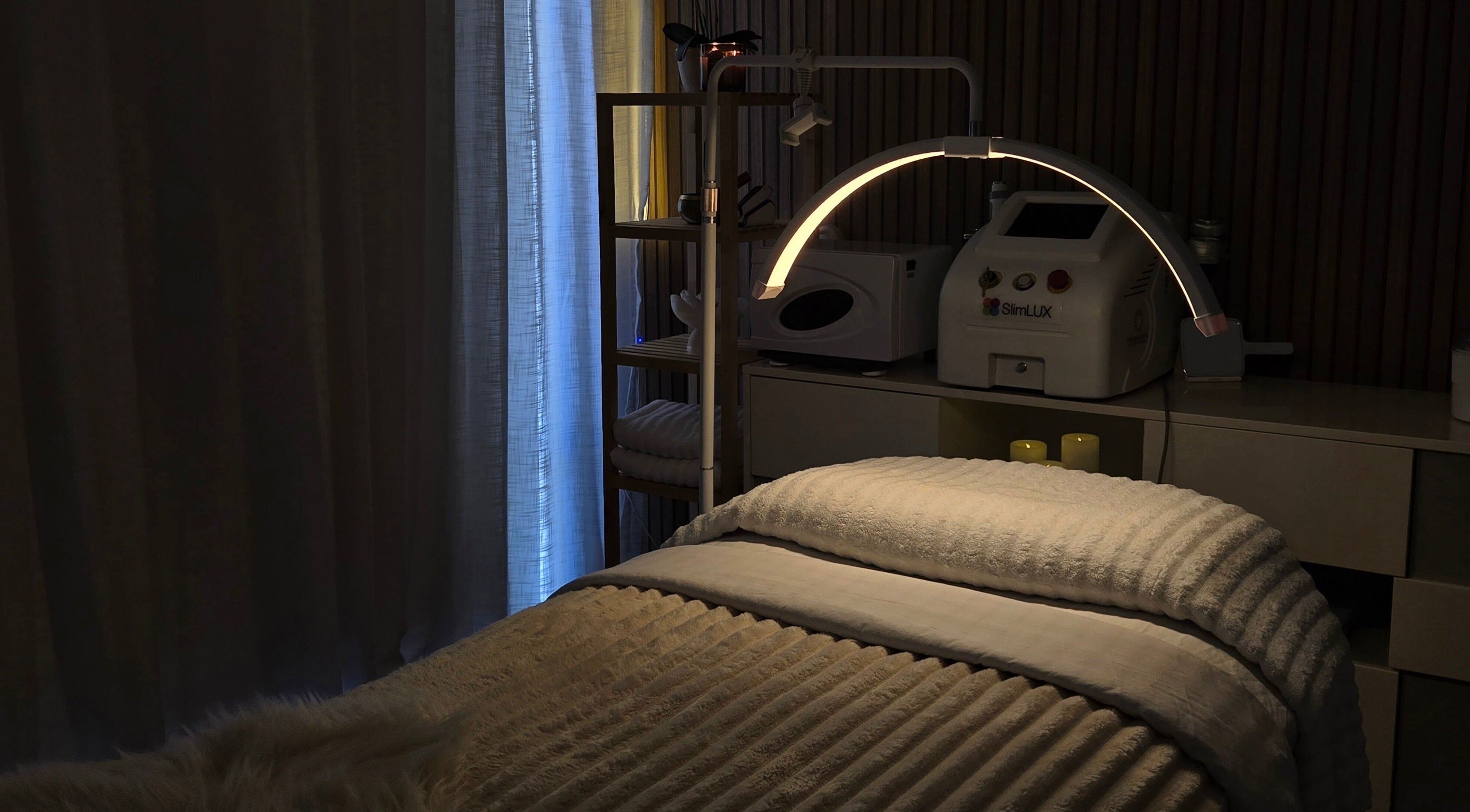 Cozy treatment room at Koda Beauty Studio in Forrestdale, Western Australia, AU with ambient lighting and equipment.