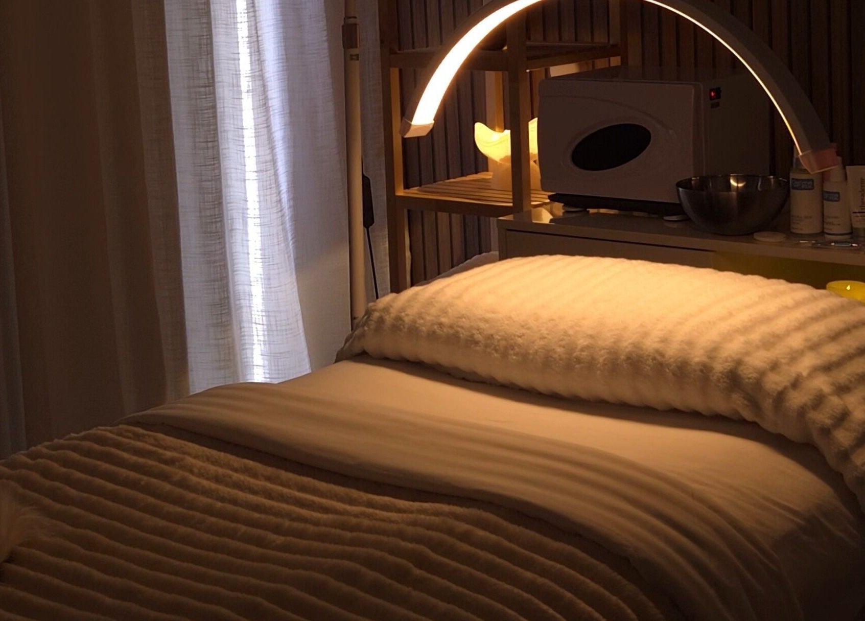 Cozy treatment room at Koda Beauty Studio, Forrestdale, Western Australia, AU with soft lighting and plush bedding.