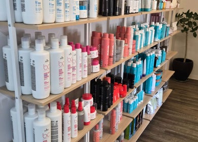 Shelves with beauty products at Revel Studio in London, Ontario, CA. An organized display of hair care items.