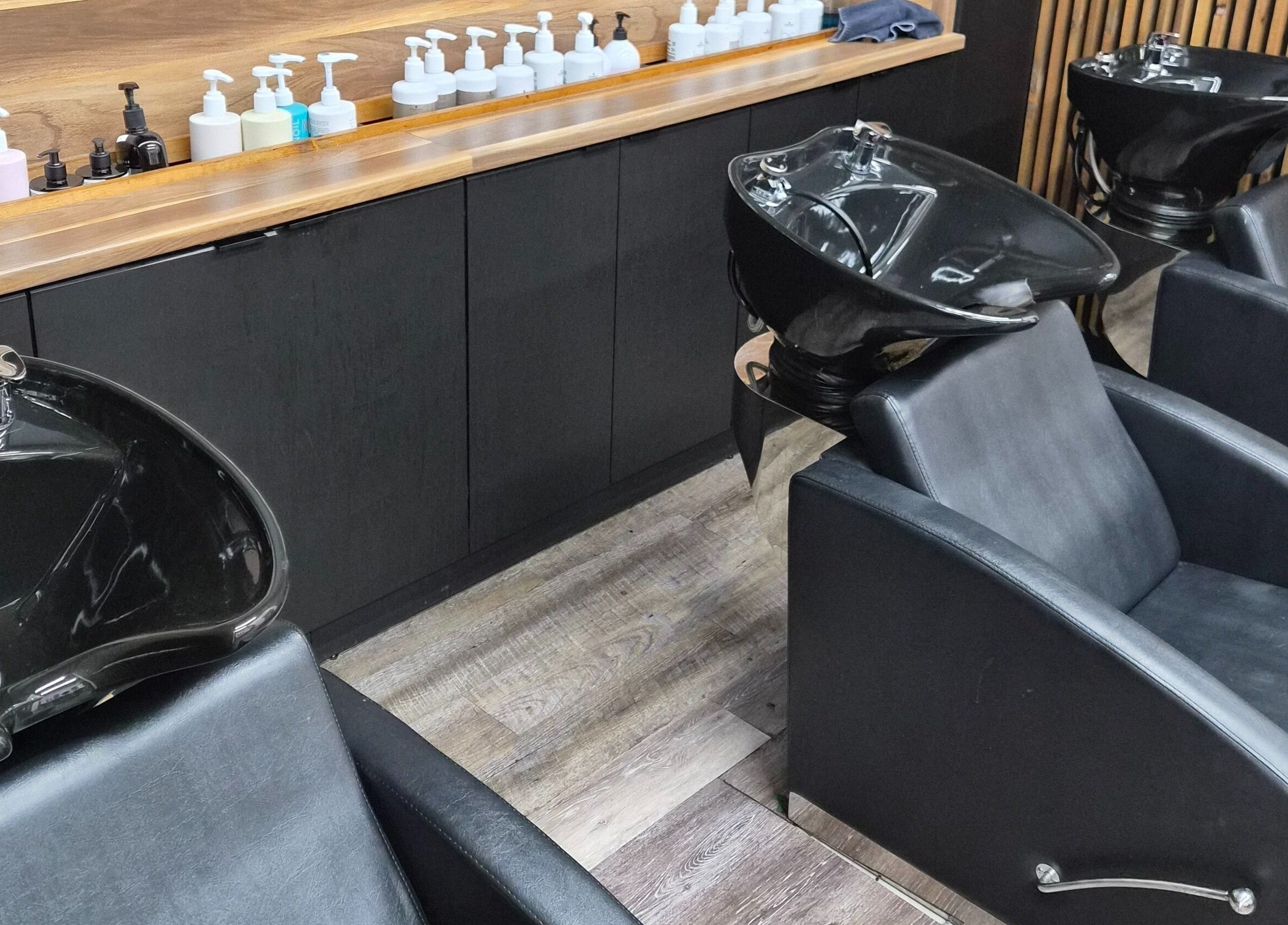 Elegant wash stations at Revel Studio, London, Ontario, CA. Modern design for ultimate client comfort and style.