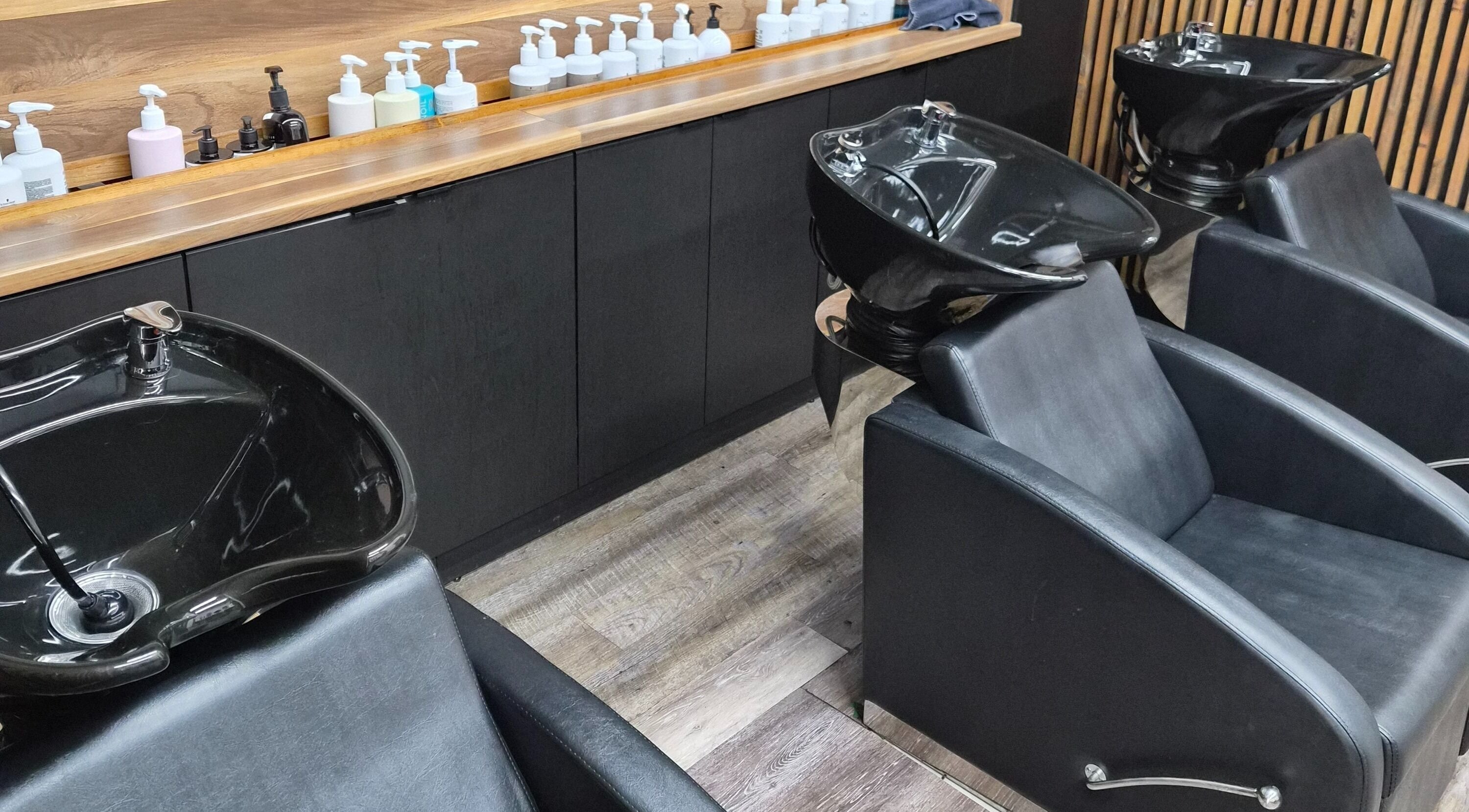 Elegant wash stations at Revel Studio, London, Ontario, CA. Modern design for ultimate client comfort and style.