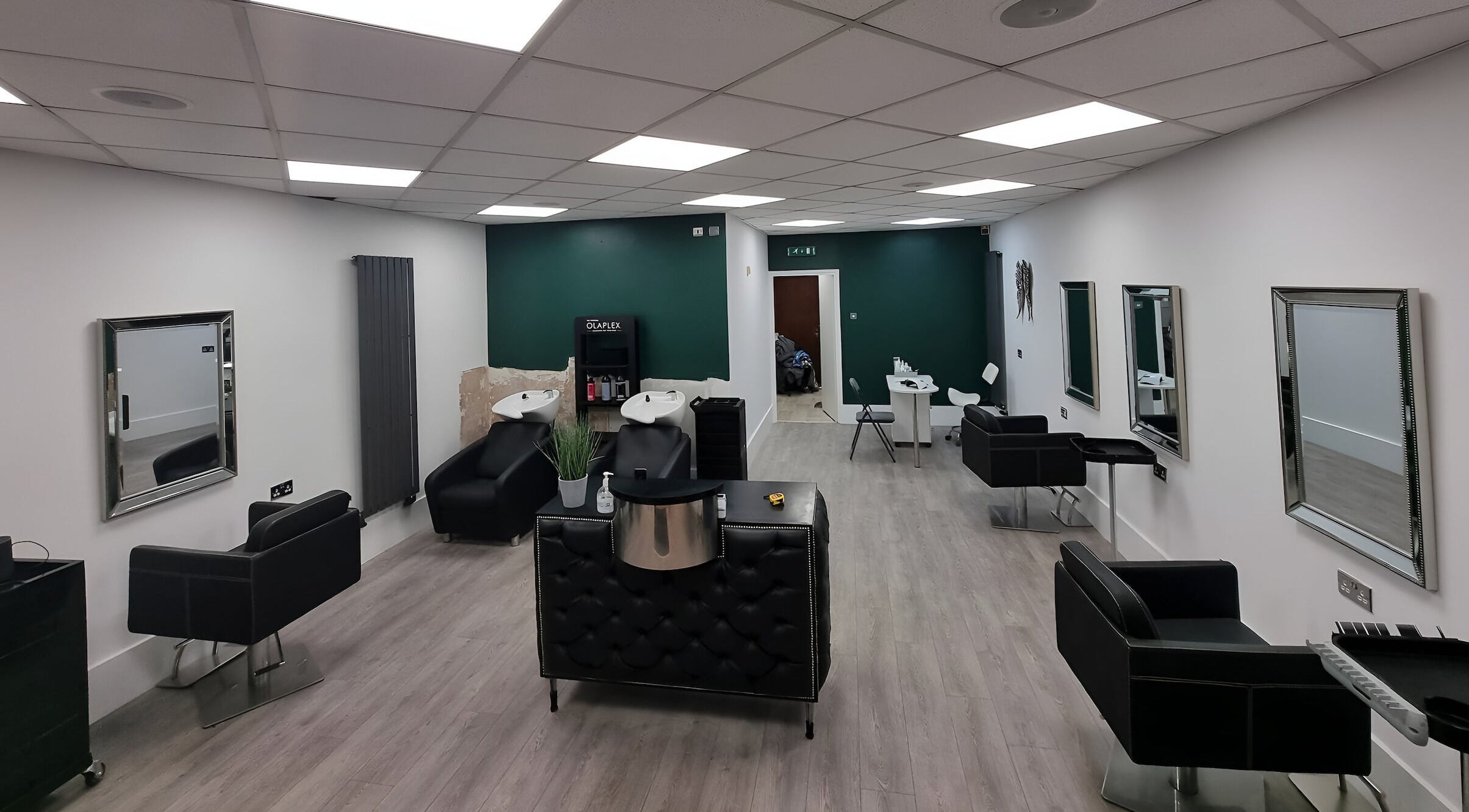 Modern salon with sleek black chairs at Chequers Hair and Beauty, Norton Canes, Cannock, England, GB.