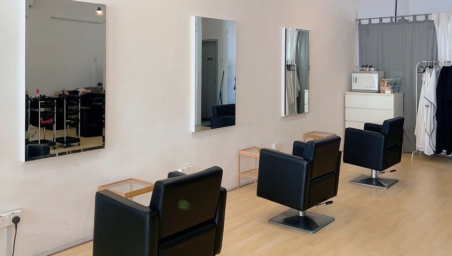 Modern salon interior at Hair Detail Studio in Balakong, Selangor, MY, featuring stylish black chairs and mirrors.