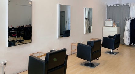 Modern salon interior at Hair Detail Studio in Balakong, Selangor, MY, featuring stylish black chairs and mirrors.