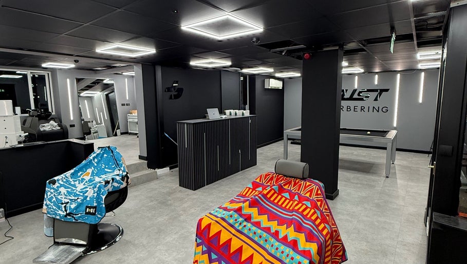 Interior of Just Barbering, Isle Of Man, Onchan, IM with stylish chairs and sleek design.