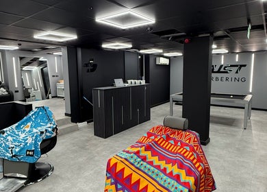 Interior of Just Barbering, Isle Of Man, Onchan, IM with stylish chairs and sleek design.