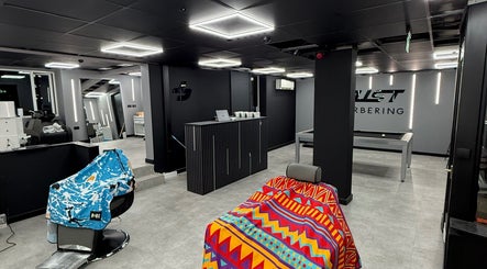Interior of Just Barbering, Isle Of Man, Onchan, IM with stylish chairs and sleek design.