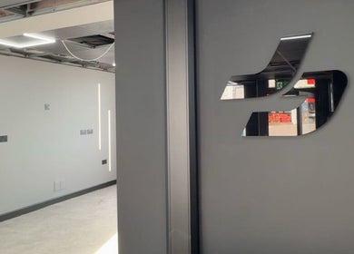 Sleek interior design of Just Barbering, Isle Of Man, Onchan, IM, with modern lighting and reflective elements.