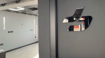 Sleek interior design of Just Barbering, Isle Of Man, Onchan, IM, with modern lighting and reflective elements.