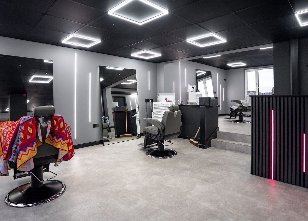 Modern interior of Just Barbering, Isle Of Man, Onchan, showcasing stylish barber chairs and contemporary lighting.