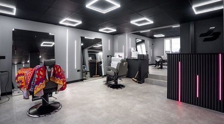 Modern interior of Just Barbering, Isle Of Man, Onchan, showcasing stylish barber chairs and contemporary lighting.