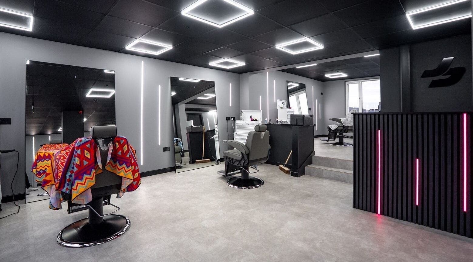 Modern interior of Just Barbering, Isle Of Man, Onchan, showcasing stylish barber chairs and contemporary lighting.