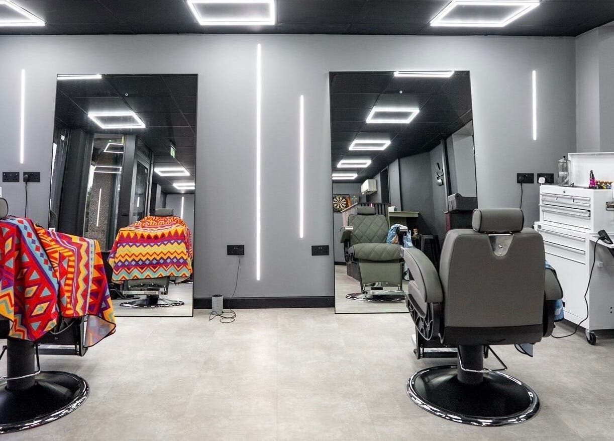 Modern barber chairs at Just Barbering, Isle Of Man, Onchan, IM, with sleek interior design.