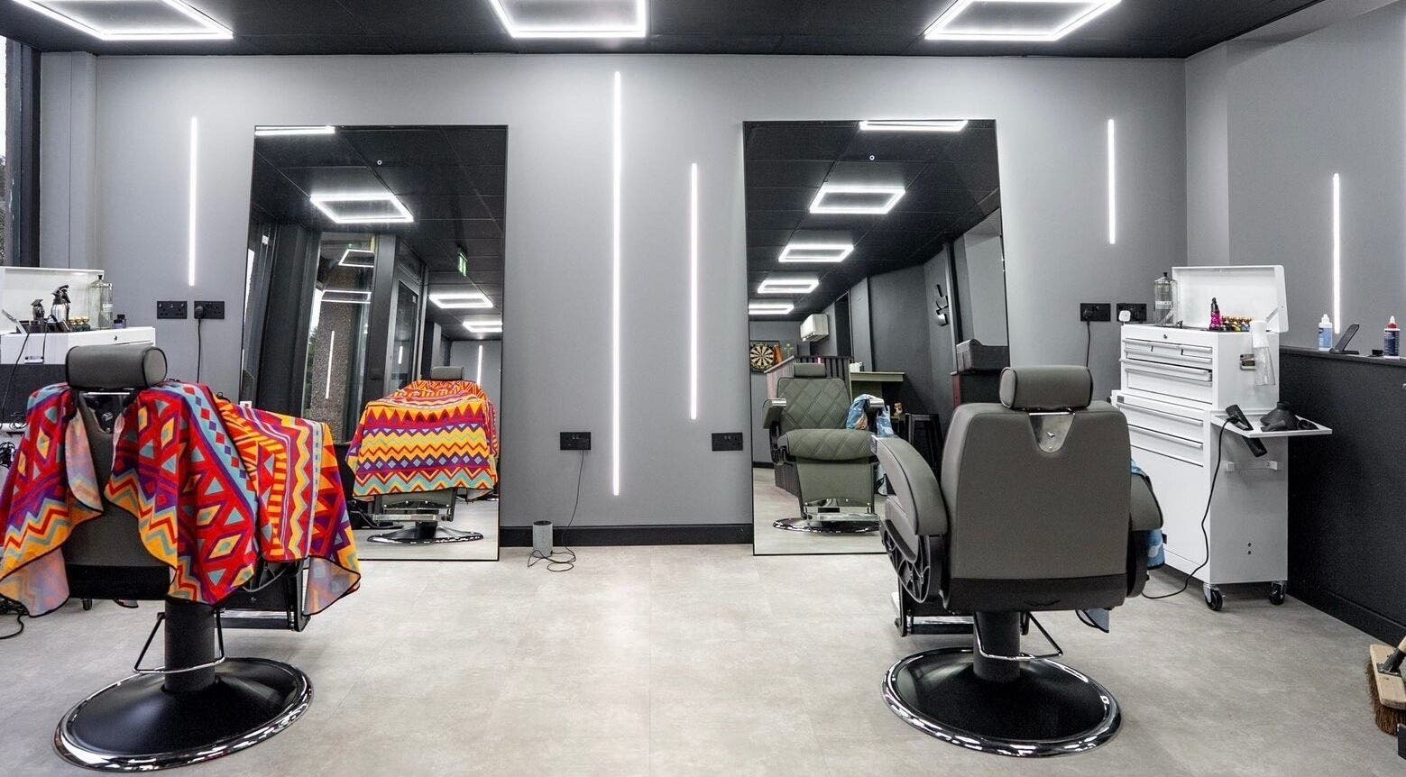 Modern barber chairs at Just Barbering, Isle Of Man, Onchan, IM, with sleek interior design.