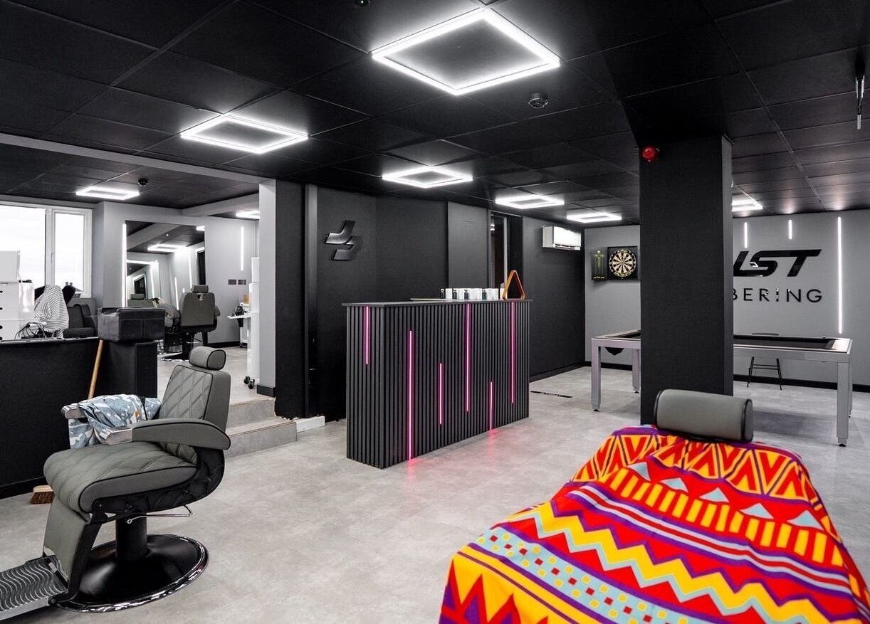 Just Barbering's modern interior in Isle Of Man, Onchan, IM features sleek chairs and stylish lighting.