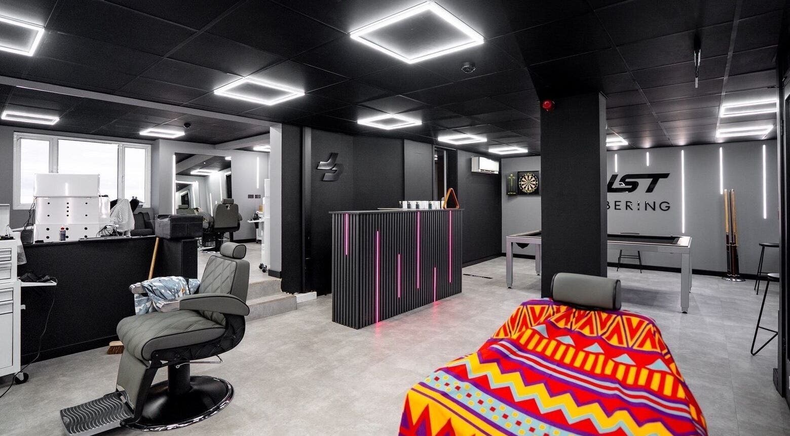 Just Barbering's modern interior in Isle Of Man, Onchan, IM features sleek chairs and stylish lighting.