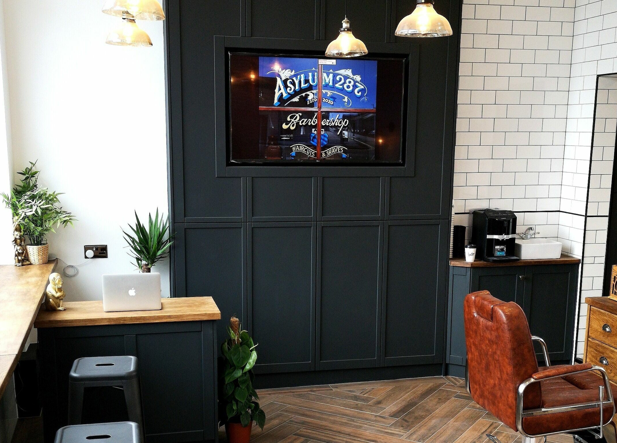 Stylish interior of Asylum287 in Barrow-in-Furness, England, GB with leather chairs and modern decor.