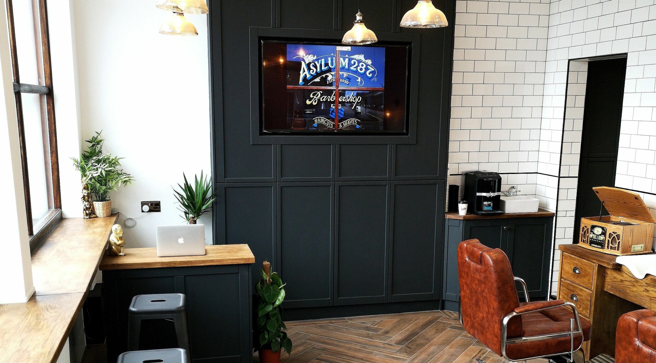 Stylish interior of Asylum287 in Barrow-in-Furness, England, GB with leather chairs and modern decor.