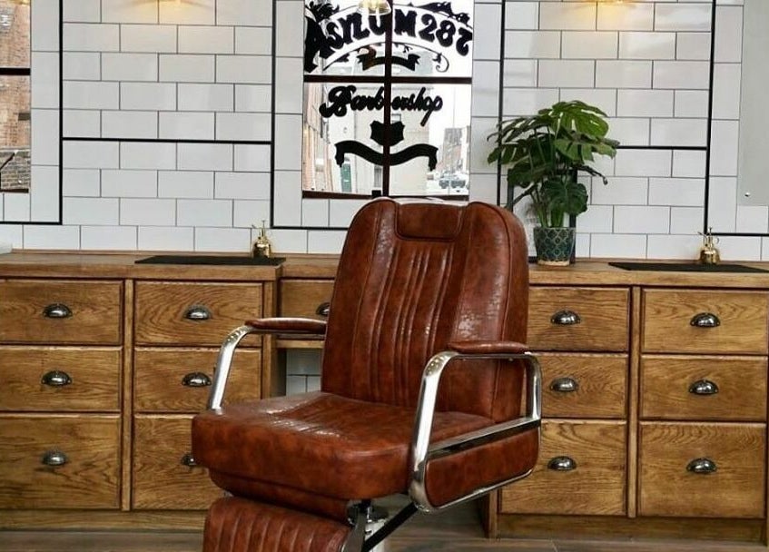Elegant vintage barber chair at Asylum287, Barrow-in-Furness, England, GB. Classic style and comfort await visitors.