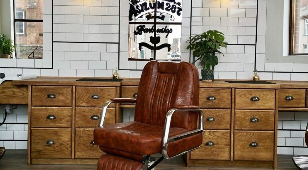 Elegant vintage barber chair at Asylum287, Barrow-in-Furness, England, GB. Classic style and comfort await visitors.