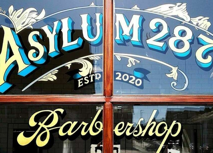 Sign of Asylum287 barbershop in Barrow-in-Furness, England, GB, established in 2020.