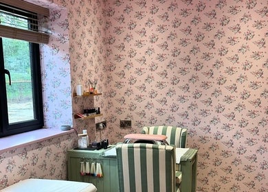 Cozy nail salon with floral wallpaper at Get Nails & Lashes, Whittlesey, GB.