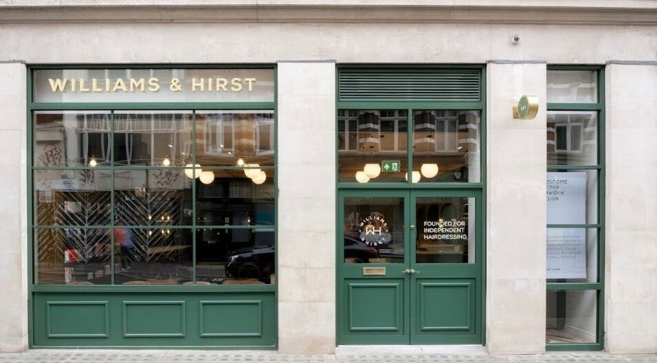 Elegant green storefront of Hollie Rose Clarke in London, England, GB, with inviting glass windows.