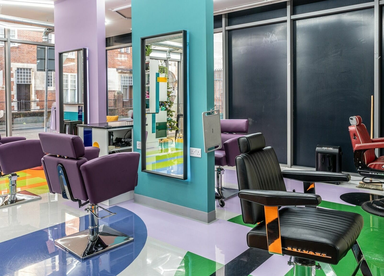 Inside Fruittii London, England, GB: colorful styling chairs and modern decor in a chic beauty salon.