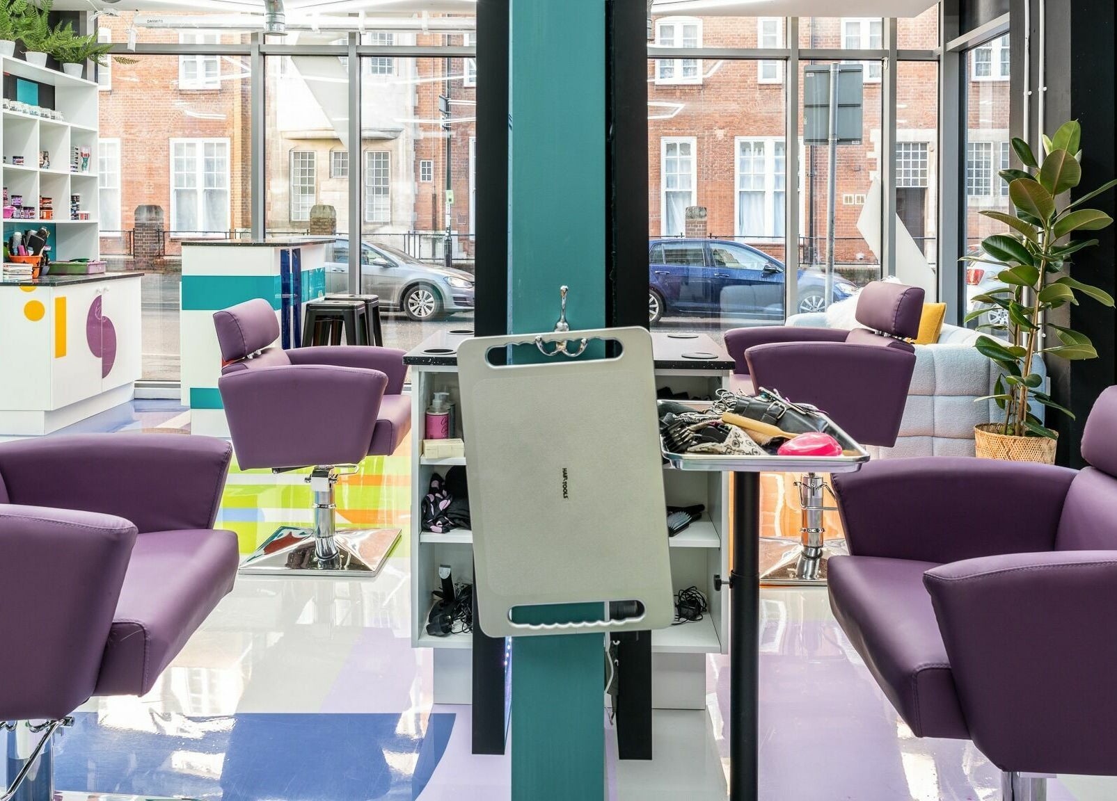 Modern salon interior at Fruittii London, featuring purple chairs and stylish decor in London, England, GB.