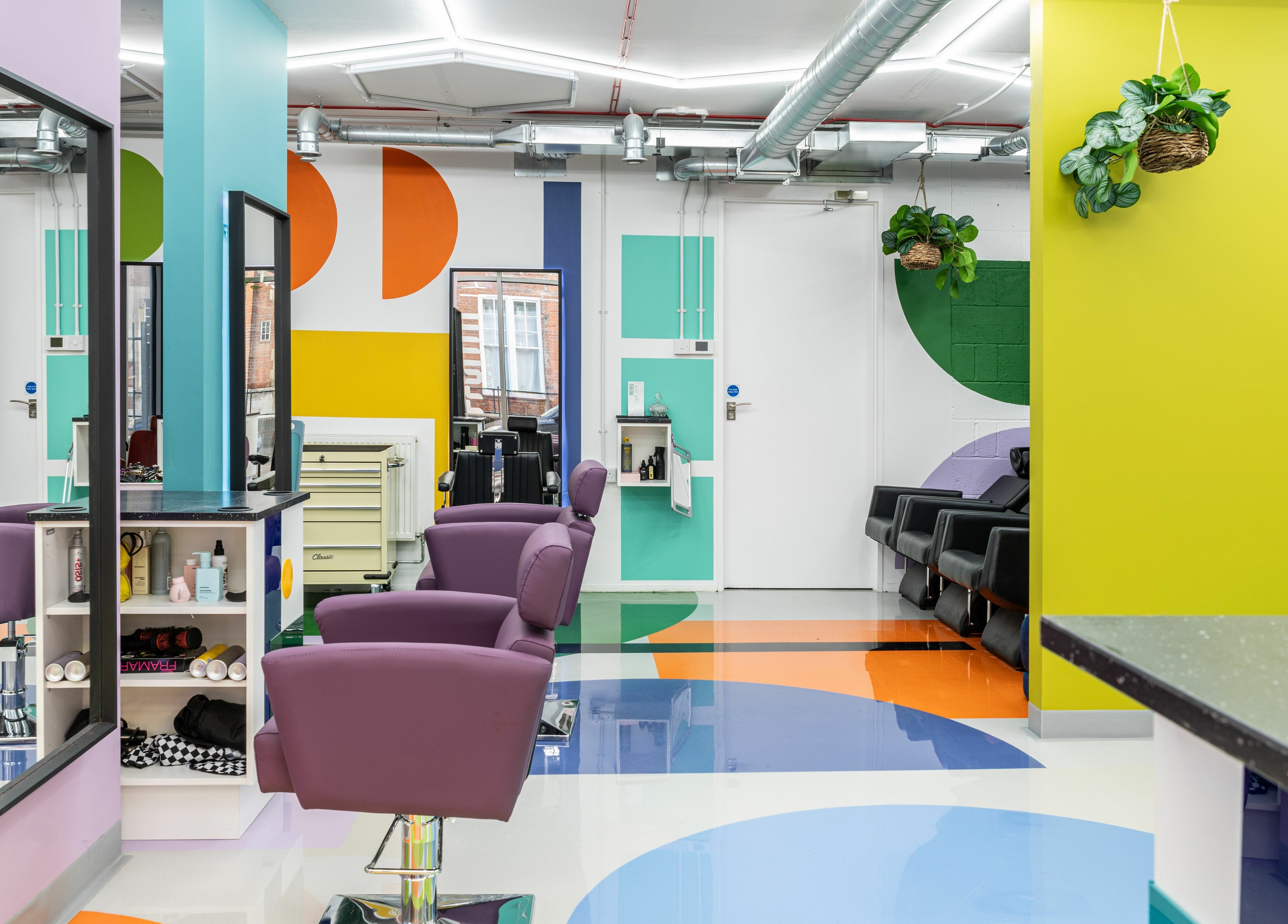 Bright, colorful salon interior at Fruittii London, London, England, GB with modern décor and stylish seating.