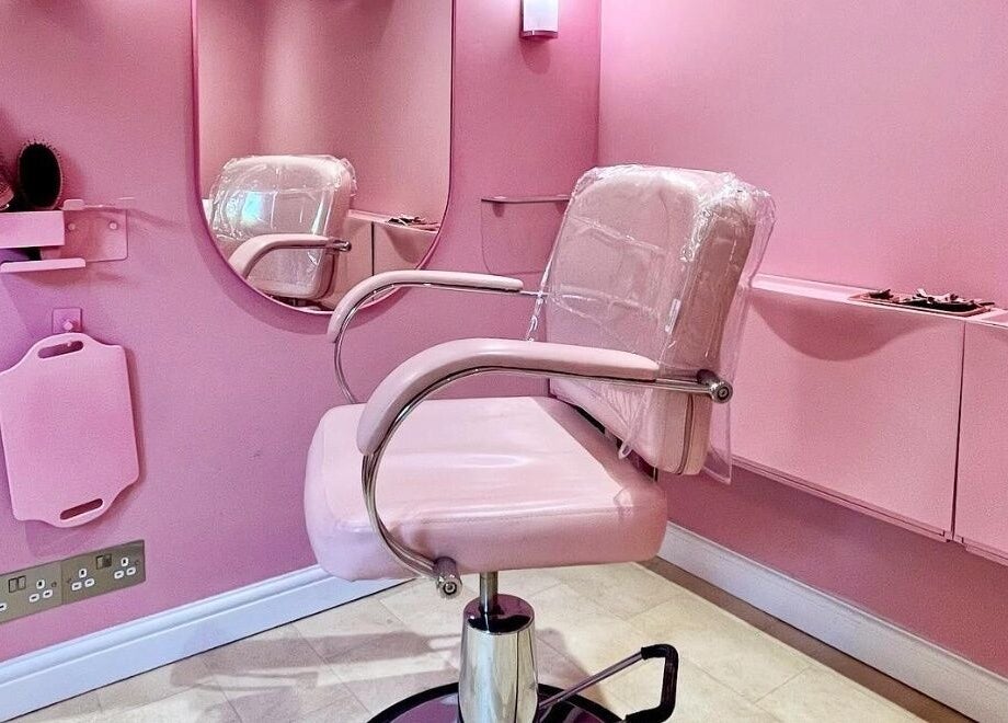 Chic pink salon chair and mirror at Lucilles Locks, Long Eaton, England, GB offering a modern beauty experience.