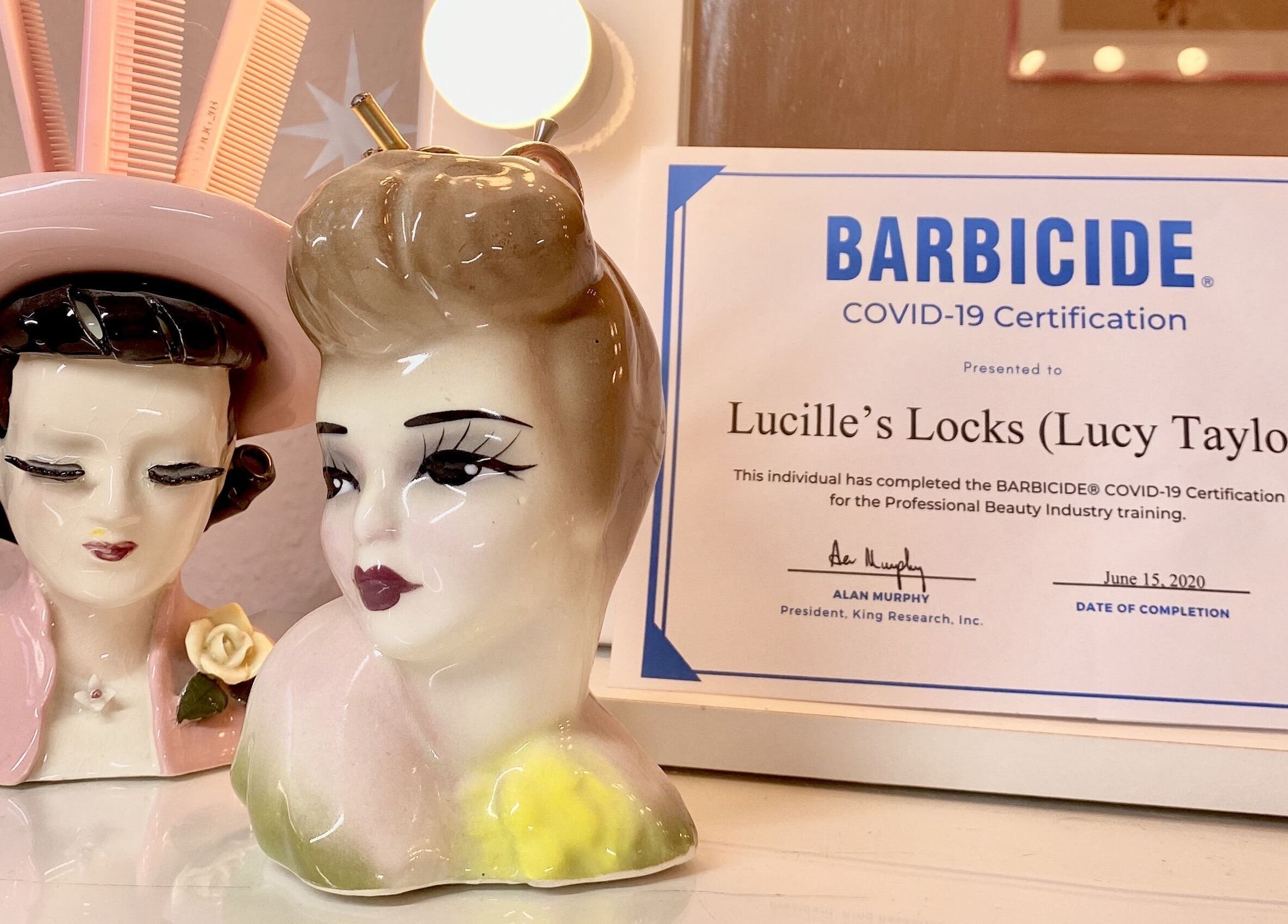 Lucille's Locks in Long Eaton, England showcases Barbicide certification with vintage ceramics.
