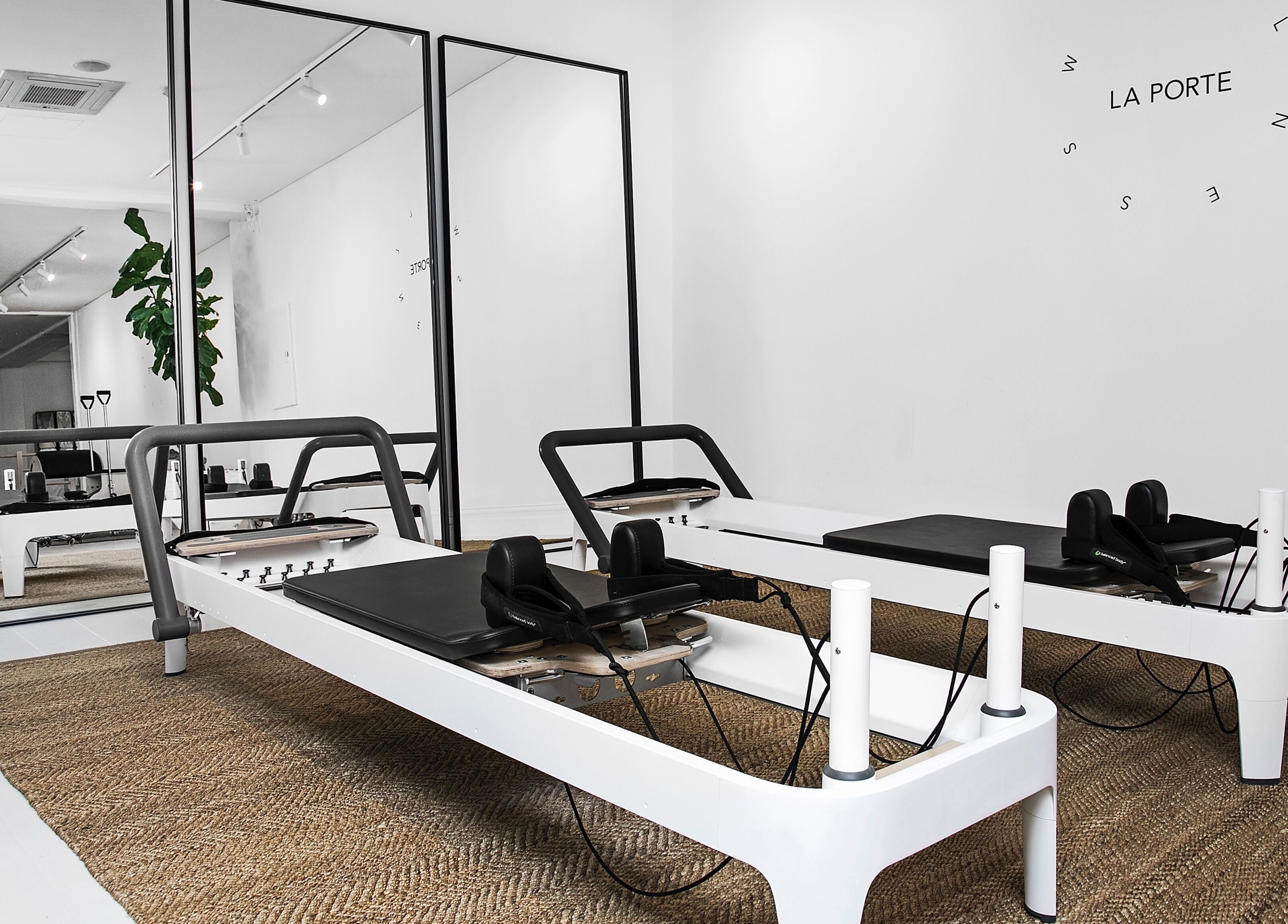 Modern Pilates studio at La Porte Wellness in Rosebery, New South Wales, AU with sleek reformer machines.